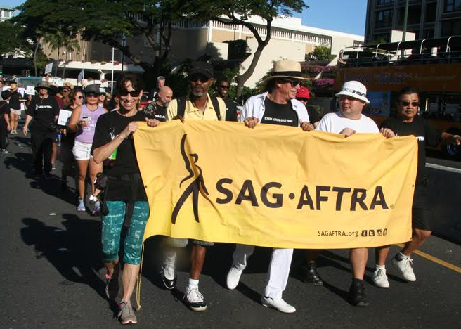 Hawaii Local SAG-AFTRA members waving our signs in the parade