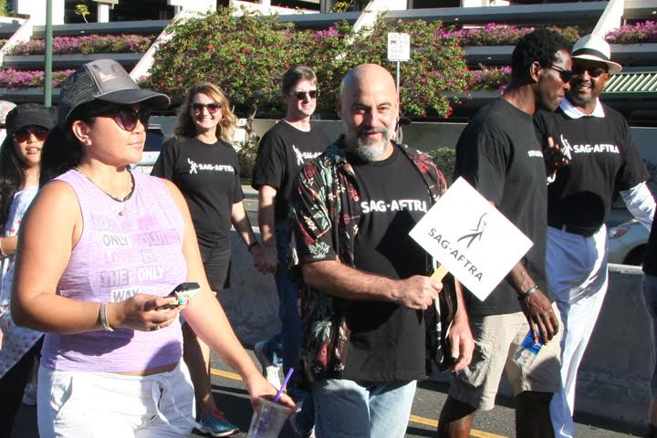 Hawaii Local SAG-AFTRA members waving our signs in the parade