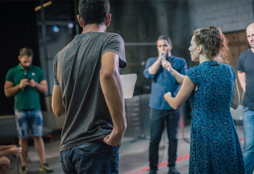 A group of actors participate in an exercise during a workshop.