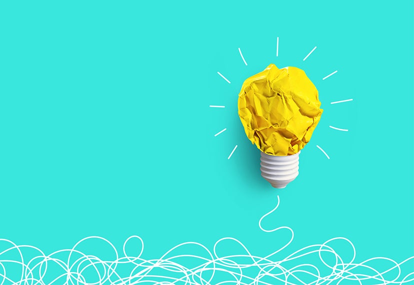 A yellow lightbulb on a teal background