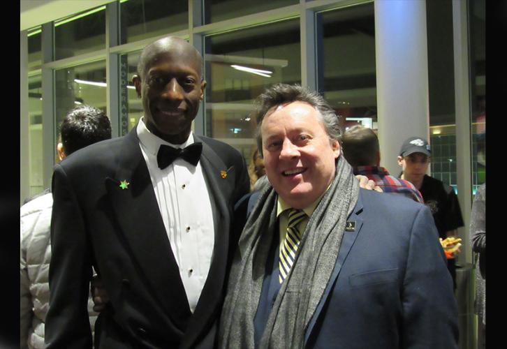 Local member Bruce McBarnette wearing a tuxedo beside Lance Lewman at the happy hour.