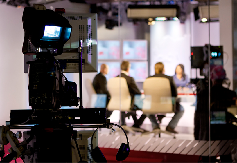 Broadcasters Sitting At A Table