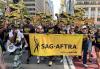 New York Local President Ezra Knight, center; New York Local Vice President Linda Powell; and members Samantha Mathis and Julianne Moore lead the contingent of SAG-AFTRA members and supporters up Fifth Avenue at the 2023 NYC-CLC Labor Day Parade and March