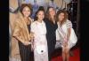 Three young girls and their mother on the red carpet.